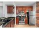 Modern kitchen featuring stainless steel appliances and dark wood cabinetry at 3302 N 7Th St # 226, Phoenix, AZ 85014