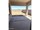 Open covered patio overlooking a large backyard and block wall at 43513 N Wollemi St, Queen Creek, AZ 85140