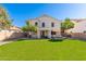 Spacious backyard with lush green grass and a covered patio perfect for outdoor entertaining and relaxation at 4660 E Torrey Pines Ln, Chandler, AZ 85249