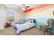 Bright bedroom featuring a colorful mural, ceiling fan, and a sunlit window at 4660 E Torrey Pines Ln, Chandler, AZ 85249