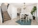 Charming dining area with tile floors, a stylish chandelier, and staircase access, great for Gathering meals at 4660 E Torrey Pines Ln, Chandler, AZ 85249