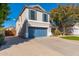 Two-story home with a long driveway, blue garage door and shutters at 4660 E Torrey Pines Ln, Chandler, AZ 85249