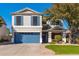 Inviting two-story home with blue accents, a well-manicured lawn, and a convenient two-car garage at 4660 E Torrey Pines Ln, Chandler, AZ 85249