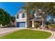 Charming two-story home featuring a lush green lawn, a blue garage door and shutters at 4660 E Torrey Pines Ln, Chandler, AZ 85249