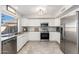 Bright kitchen featuring stainless steel appliances, granite countertops, and white cabinetry, ideal for cooking at 4660 E Torrey Pines Ln, Chandler, AZ 85249