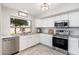 Well-lit kitchen featuring stainless steel appliances, granite countertops, and white cabinets, perfect for chefs at 4660 E Torrey Pines Ln, Chandler, AZ 85249