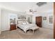 Spacious main bedroom featuring neutral tones, ceiling fan, a bench, and lots of natural lighting at 4660 E Torrey Pines Ln, Chandler, AZ 85249