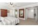 Spacious main bedroom with neutral tones, ceiling fan, walk-in shower, and large framed mirror at 4660 E Torrey Pines Ln, Chandler, AZ 85249