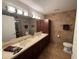 Bright bathroom featuring a double vanity, decorative accents, and a tiled shower with glass door at 7151 E Rancho Vista Dr # 4001, Scottsdale, AZ 85251
