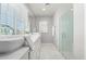 Bright bathroom featuring dual vessel sinks, marble countertops, decorative tile and a glass enclosed shower at 735 E Calavar Rd, Phoenix, AZ 85022