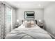 Inviting bedroom with a comfortable bed, modern artwork, and large window for ample natural light at 735 E Calavar Rd, Phoenix, AZ 85022