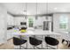 Modern kitchen with white cabinets, quartz countertops, stainless steel appliances, and a large kitchen island at 735 E Calavar Rd, Phoenix, AZ 85022