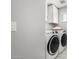 Modern laundry room equipped with a washer, dryer, and sleek white cabinetry at 735 E Calavar Rd, Phoenix, AZ 85022