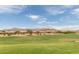 View of homes and golf course with mountain backdrop at 7943 E Aloe Cir, Gold Canyon, AZ 85118