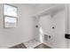 Laundry room with shelving, tile floor, and window at 18337 W Poston Dr, Surprise, AZ 85387