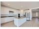 Contemporary kitchen with white cabinetry, stainless steel appliances, kitchen island and hardwood floors at 25353 N 176Th Ave, Surprise, AZ 85387