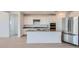 Modern kitchen featuring white cabinets, stainless steel appliances, a large island, and recessed lighting at 25353 N 176Th Ave, Surprise, AZ 85387