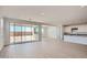 Open-concept living room with tile floors, recessed lighting, and a seamless flow into the modern kitchen at 25353 N 176Th Ave, Surprise, AZ 85387