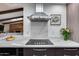 Modern kitchen features a gas cooktop and marble backsplash at 26434 S Hogan Dr, Sun Lakes, AZ 85248