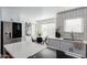 Updated kitchen with white shaker cabinets, quartz countertops, and breakfast bar at 3500 N Hayden Rd # 1902, Scottsdale, AZ 85251