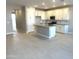 Bright, open kitchen showcases white cabinets, a center island, and sleek countertops at 43401 N Wollemi St, Queen Creek, AZ 85140