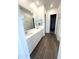 Bathroom with double sinks, tile floor, and a large mirror at 43429 N Wollemi St, Queen Creek, AZ 85140