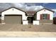 Charming single-story home featuring a neutral-colored stucco finish, tile roofing, and an attached two-car garage at 43429 N Wollemi St, Queen Creek, AZ 85140