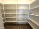 Walk-in pantry with custom shelving offers lots of storage space at 43499 N Wollemi St, Queen Creek, AZ 85140