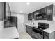 Modern galley kitchen with dark cabinetry and quartz countertops at 805 N 4Th Ave # 609, Phoenix, AZ 85003
