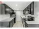 Modern galley kitchen with dark cabinetry and quartz countertops at 805 N 4Th Ave # 609, Phoenix, AZ 85003