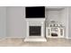 Clean fireplace with mounted TV and decorative cabinet in a well-lit room at 9982 W Villa Chula --, Peoria, AZ 85383