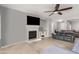 Living room with fireplace, TV, ceiling fan, and comfortable seating arrangement at 9982 W Villa Chula --, Peoria, AZ 85383