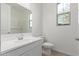 Bright bathroom features a white vanity, white subway tile and a window for lots of natural light at 12337 W Marguerite Ave, Avondale, AZ 85323