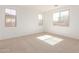 Bright bedroom with neutral carpeting, recessed lighting, and three windows at 12337 W Marguerite Ave, Avondale, AZ 85323