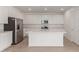 Bright kitchen featuring stainless steel appliances, an island with a sink, and white cabinets at 12337 W Marguerite Ave, Avondale, AZ 85323