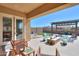 Relaxing back patio area with pavers, seating, pergola, and artificial turf at 18169 W Cactus Flower W Dr, Goodyear, AZ 85338