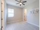 Bright bedroom features tile floors, ceiling fan, and ample natural light from large window at 18169 W Cactus Flower W Dr, Goodyear, AZ 85338