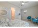 Charming bedroom featuring a floral-patterned bedspread, cool-toned walls, and decorative wall art at 18169 W Cactus Flower W Dr, Goodyear, AZ 85338