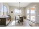 Charming dining area with modern light fixture and french doors leading to outdoor pool at 18169 W Cactus Flower W Dr, Goodyear, AZ 85338