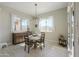 Bright dining room features wood table, chandelier, and large windows bringing in plenty of natural light at 18169 W Cactus Flower W Dr, Goodyear, AZ 85338