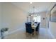 Bright dining room with large windows, a modern chandelier, and stylish blue chairs for elegant dining at 18169 W Cactus Flower W Dr, Goodyear, AZ 85338