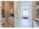 Hallway view shows a laundry room and the entrance into a bright, well-lit office space at 18169 W Cactus Flower W Dr, Goodyear, AZ 85338