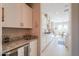 Well-lit kitchen features granite countertops, stainless steel appliances, and sleek white cabinets at 18169 W Cactus Flower W Dr, Goodyear, AZ 85338