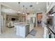 Open concept kitchen with island seating and stainless steel appliances at 18169 W Cactus Flower W Dr, Goodyear, AZ 85338