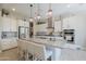 Bright kitchen with a large island, stainless steel appliances, and pendant lighting at 18169 W Cactus Flower W Dr, Goodyear, AZ 85338