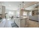 Well-lit kitchen featuring an island with bar stools, stainless steel appliances at 18169 W Cactus Flower W Dr, Goodyear, AZ 85338