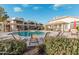 Community pool area with lounge chairs and tables at 1825 W Ray Rd # 2060, Chandler, AZ 85224