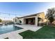 Outdoor kitchen, pool, and patio with string lights at 20404 W Crescent Dr, Buckeye, AZ 85396