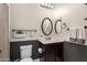 Bathroom with dark vanity, decorative wall accents, and a toilet at 20404 W Crescent Dr, Buckeye, AZ 85396