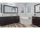 Elegant bathroom with double vanity, soaking tub, and dark wood cabinets at 20404 W Crescent Dr, Buckeye, AZ 85396